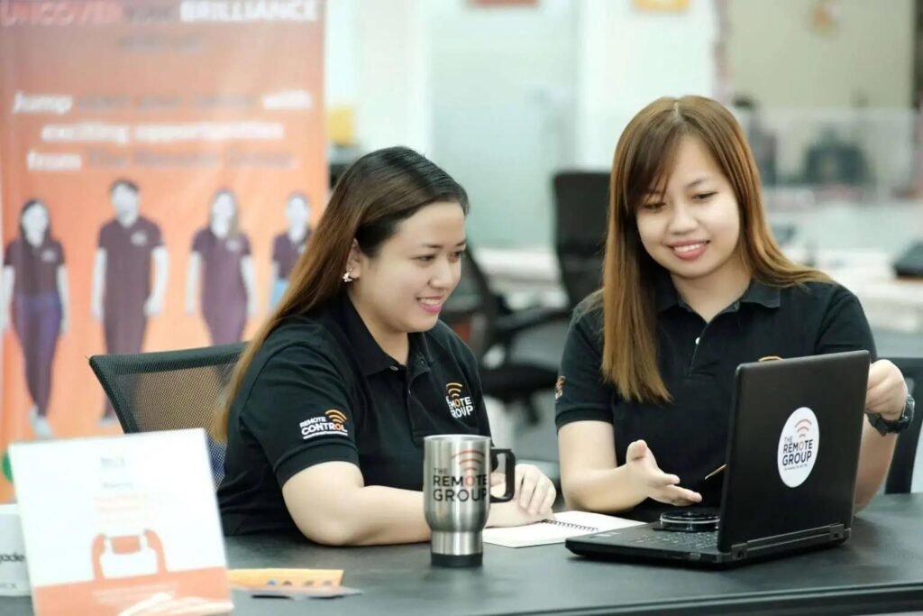 Two women collaborating over a laptop.